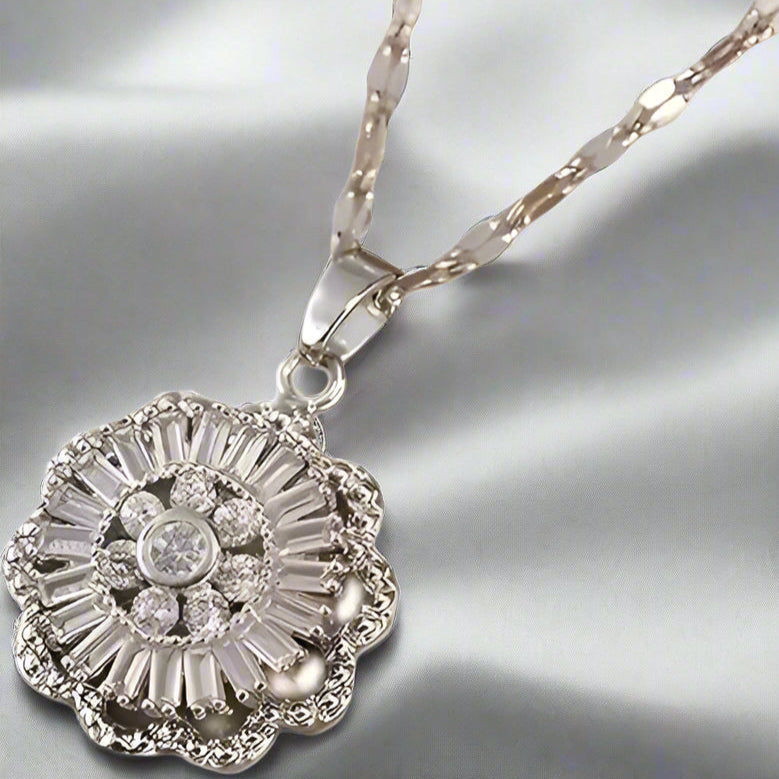 Silver necklace with a floral pendant on a white background
