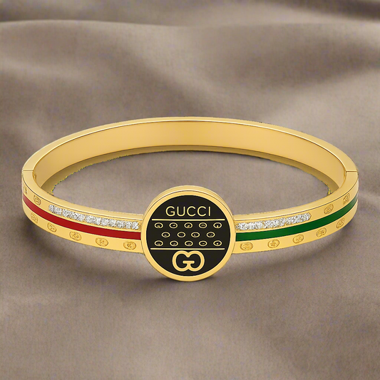 Gold bracelet with Gucci logo on a white background