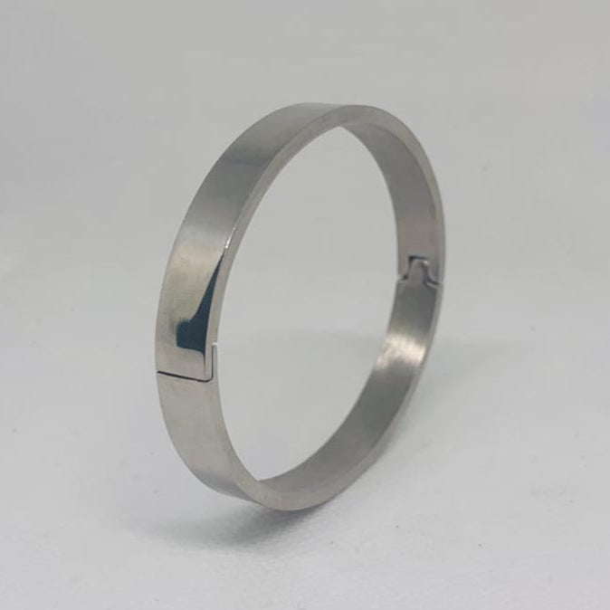 Silver ring on a light gray background