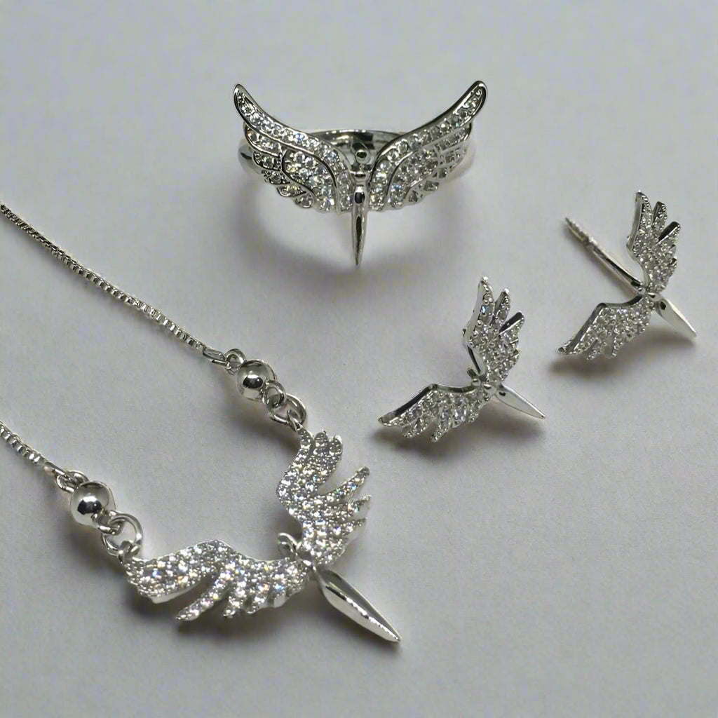 Silver jewelry set with wing-shaped pendant and earrings on a white background