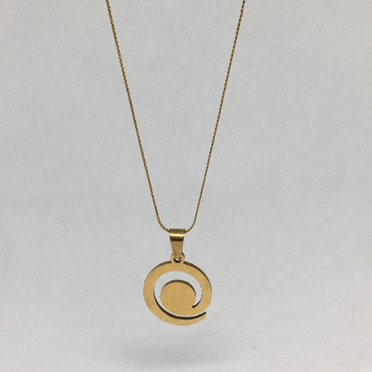 Gold necklace with a circular pendant on a light gray background