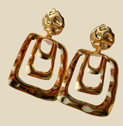 This image displays a pair of elegant stainless steel earrings, featuring a sophisticated star design. The earrings are crafted in a golden hue, enhancing their sophisticated appeal.