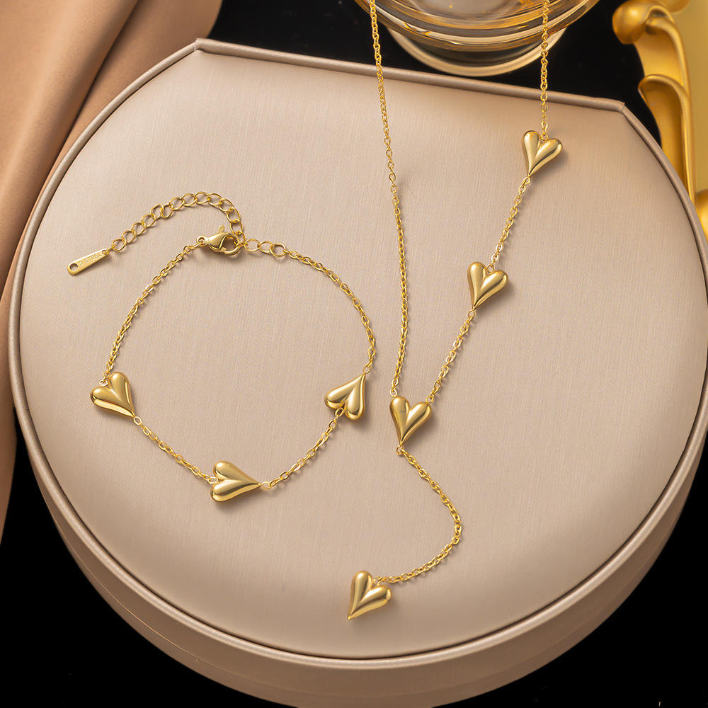 Gold heart-shaped bracelet and necklace