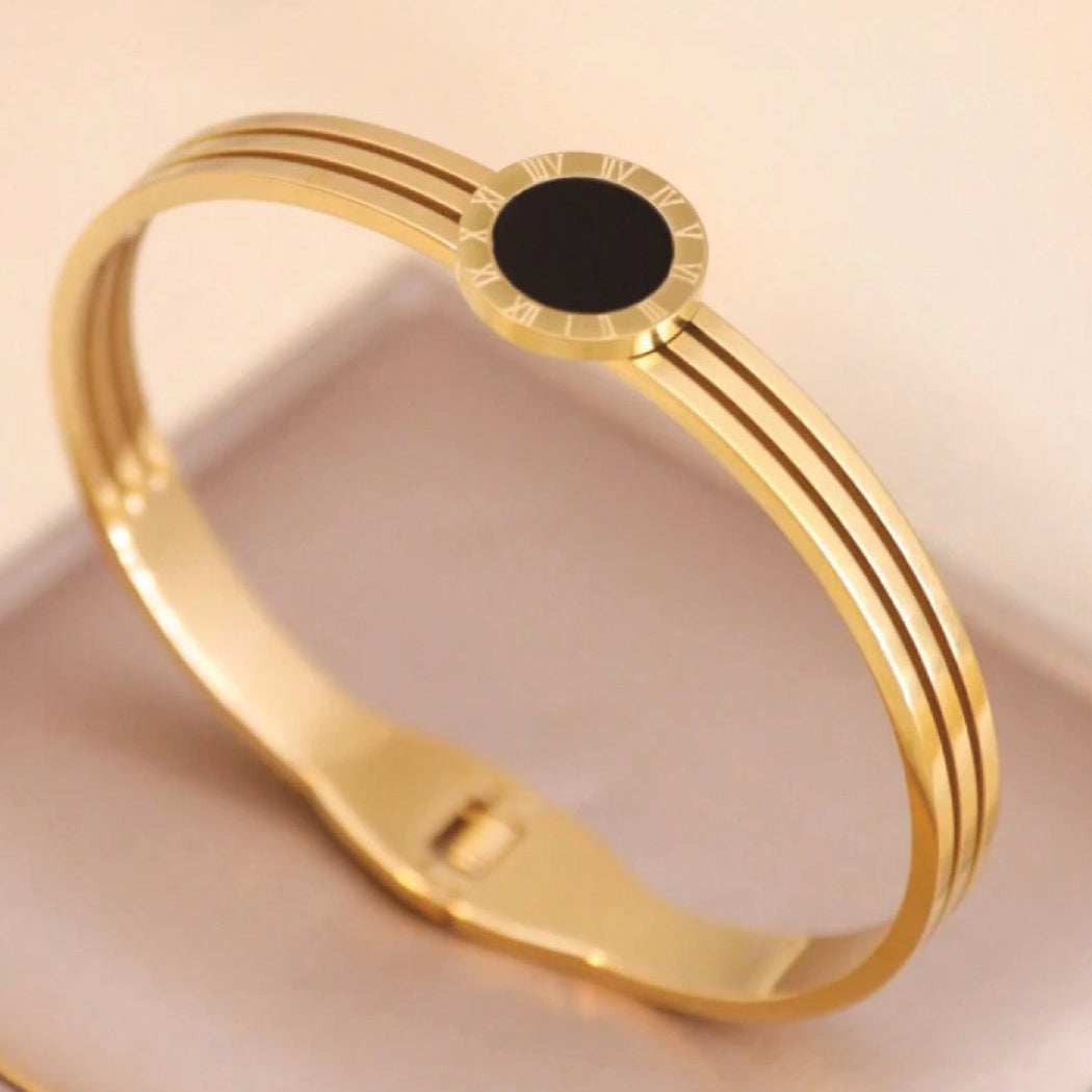 Gold bracelet with a black