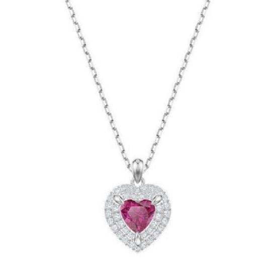A heart-shaped pendant with a red stone in the center, encased in clear crystal, with a silver-colored band and chain.